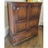 A good quality old English style oak side cupboard with distressed finish and enclosed by a pair