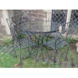 A contemporary ironwork four piece garden terrace suite, with scrolled and bound arrow detail, the