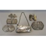 A silver evening purse with engraved detail and five worldwide silver/white metal two part belt