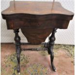 A mid Victorian period walnut and figured walnut ladies sewing/games table, the serpentine front