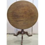 An early 19th century mahogany snap top occasional table of circular form raised on ring turned