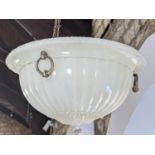 An Edwardian opaque glass hanging ceiling shade with fluted floral detail, cast brass ring handles