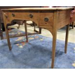 A 19th century stripped pine bow fronted kneehole side/dressing table fitted with three frieze