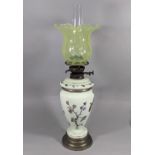 A Victorian opaque glass oil lamp with hand painted floral detail supporting a double burner and a