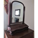 A Victorian toilet mirror of arched form with moulded frame and turned tapered column supports,