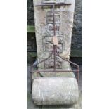 A 19th century or possibly earlier stone garden roller with wrought iron T shaped handle, stamped to