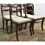 Four Regency mahogany dining chairs with carved and shaped splats and cresting rails, drop-in seats,