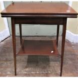 Small inlaid Edwardian mahogany fold over top card table raised on four square taper legs with under