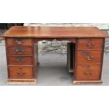 A 19th century mahogany kneehole office desk with rectangular top raised on a pair of pedestals,