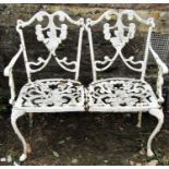 A cream painted cast alloy two seat garden bench, with pierced and scrolling rose detail, open