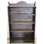 A 1920s oak freestanding open bookcase with fixed shelves, applied split bead mouldings and shaped