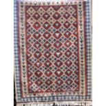 A Kelim rug with geometric pale decoration upon an orange ground, 145 x 105 cm