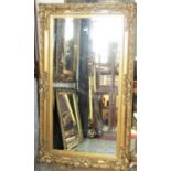 An antique style wall mirror with rectangular bevelled edge plate within a stepped and moulded