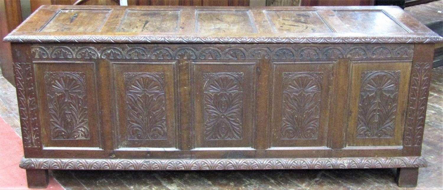 A substantial Georgian oak coffer with repeating geometric detail, within a panelled framework,