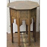 An Indian hardwood occasional table of octagonal form, with repeating inlaid geometric brass detail,