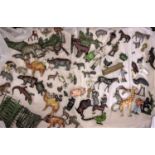 A box of lead painted toys, many by Britains including farm and zoo animals, people, tools, fencing,