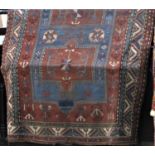 Good antique Turkish Kazah with unusual blue medallions upon a burnt orange/brown ground, 250 x