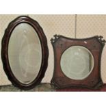 A 1920s wall mirror with circular bevelled edge plate within an oak frame with curved sides and