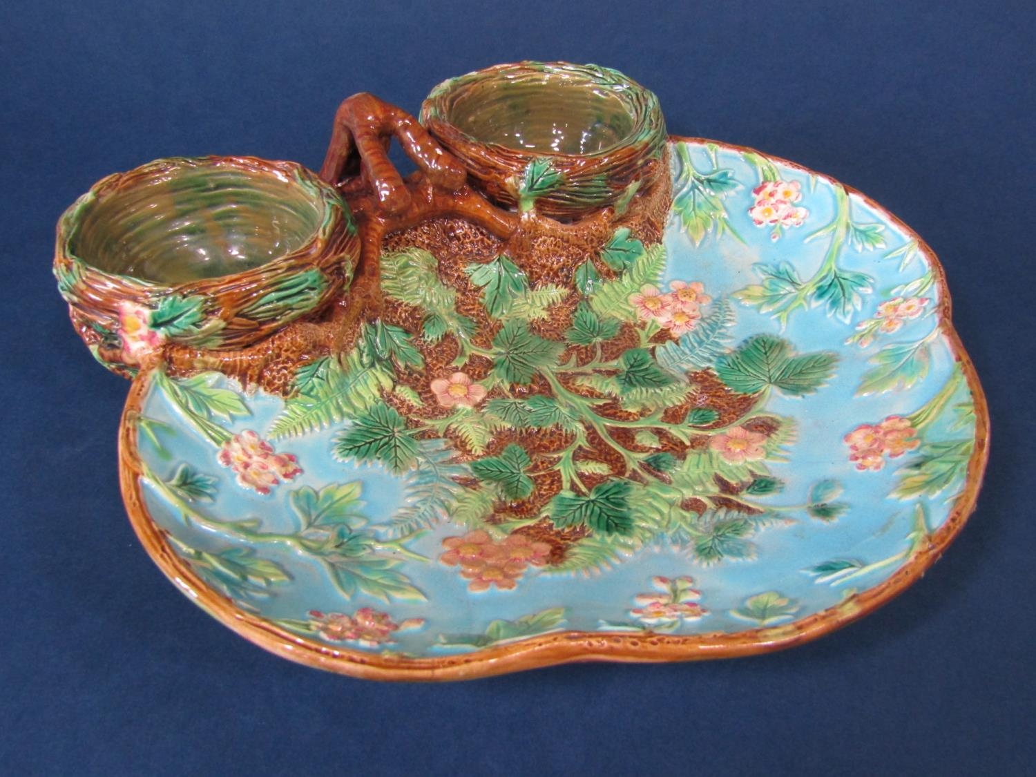 A 19th century majolica strawberry dish by George Jones, modelled as a pair of nests with strawberry