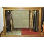 An Edwardian overmantle mirror with rectangular bevelled edge plate within a reeded frame with