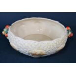 A Clarice Cliff relief moulded bowl in the Celtic Harvest pattern with moulded fruit handles and