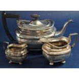 Two piece part tea service comprising faceted boat shaped teapot and milk jug upon ball feet,
