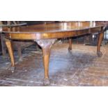 A good quality walnut D end extending dining table enclosing two additional leaves with carved and
