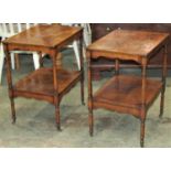 A pair of small reproduction yewwood veneered two tier side/lamp tables of rectangular form raised
