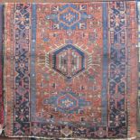 Good quality antique Karadsa rug with three central blue medallions upon a brick red ground, 135 x