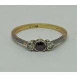 18ct ruby and diamond three stone ring, size L/M, 1.9g (one diamond needs resetting)