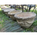 A set of six reclaimed garden planters of circular tapered form with classical tied ribbon and