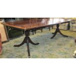 A good quality Georgian style mahogany extending dining table with satinwood crossbanding raised