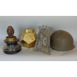 Trench art interest; - a pineapple grenade body mounted on a brass shell case, a helmet and a brass