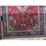 Belgian Nerahbad wall carpet decorated with floral decoration upon a red ground with navy blue