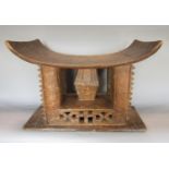 An Ashanti stool cut from a single timber with geometric and other detail