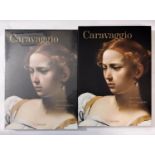 A collection of books about the artist Caravaggio including three in their original shrink