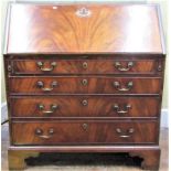 A Georgian mahogany bureau, the fall front over four long graduated drawers, all with well matched