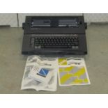 A silver Read EX43 electronic compact typewriter complete with operating manual