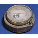 A 19th century pocket mounted barometer enclosing a small compass with paper label - mounted