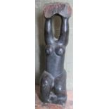 A modern art carved and polished stone sculpture, headless naked female figure, in squat kneeling