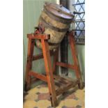 A coopered and steel banded butter churn and stand with oval plaque and stamp to casting Wade & Sons