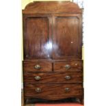 A Regency mahogany linen press, the lower section enclosed by two long and two short drawers and