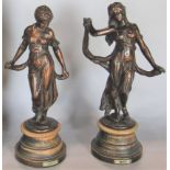 Pair of French antique bronzed spelter figures of classical maidens, on turned ebonised bases