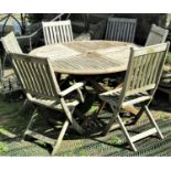 A Winchester Collection weathered teak garden table of circular form with segmented slatted top