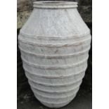 A terracotta oviform ribbed and shouldered jar with whitewash finish, 80cm high