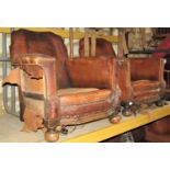 A early 20th century hide upholstered three piece cottage suite comprising wo seat sofa and a pair