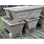 A set of four reclaimed garden planters of rectangular and tapered form with foliate detail, 82cm