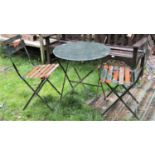 A contemporary weathered green painted light steel three piece folding bistro set together with a