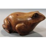 A small timber netsuke in the form of a frog