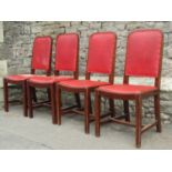 A set of eight mahogany dining chairs with arched rexine padded backs over drop-in seats raised on